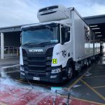 Photo of T & G truck at its depot, during washing. There are the Pure Pressure washing tools on the ground in front of the truck