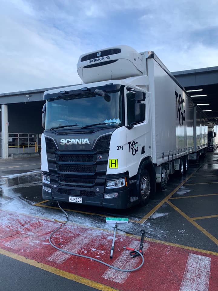 Photo of T & G truck at its depot, during washing. There are the Pure Pressure washing tools on the ground in front of the truck