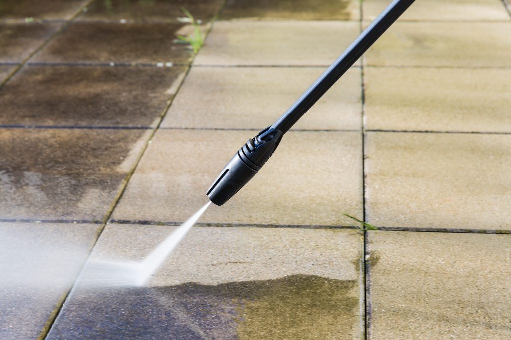 Cleaning terrace with high-pressure water blaster